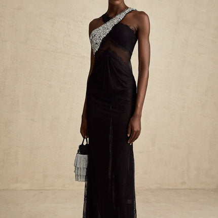 A long black maxi dress with a crossover bodice featuring crystal embellishments and a flowing skirt