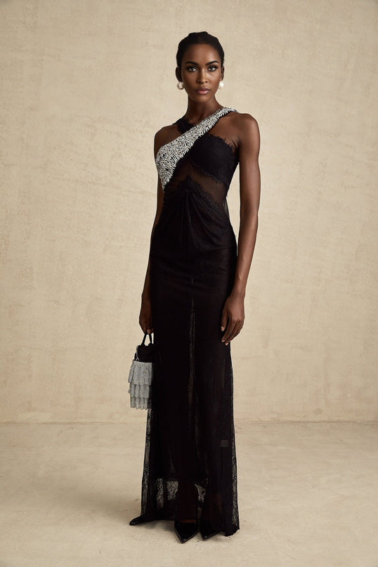 A long black maxi dress with a crossover bodice featuring crystal embellishments and a flowing skirt