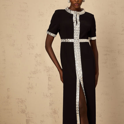 A long black maxi dress with a front slit and crystal embellishments worn by a model