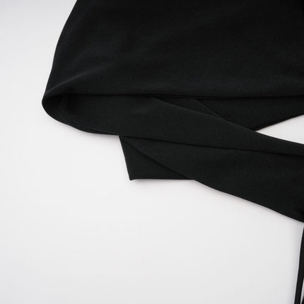 A long black maxi dress with a hood and floral applique details