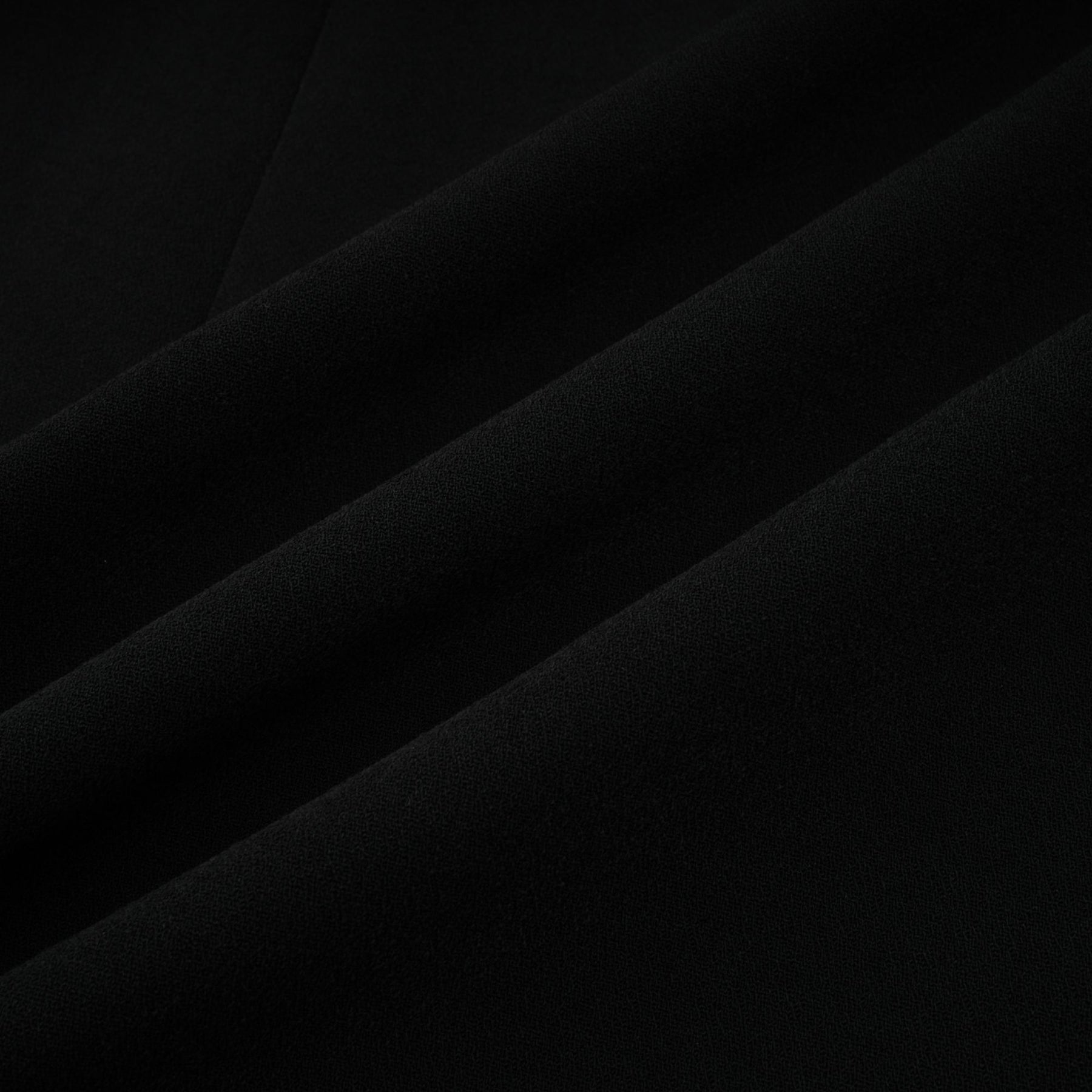 A long black maxi dress with blazer style top featuring embellishments and a feminine silhouette