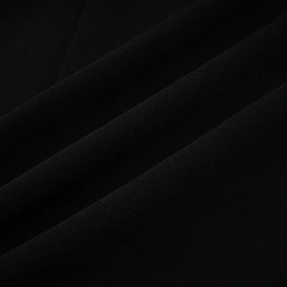 A long black maxi dress with blazer style top featuring embellishments and a feminine silhouette