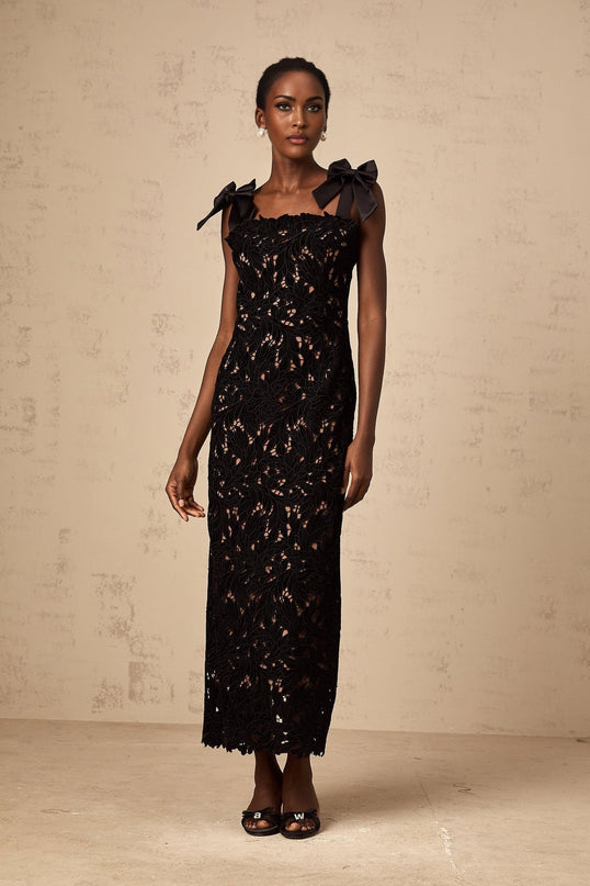 A long black maxi dress with delicate floral embroidery details featuring Eloise styling
