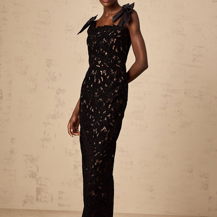 A long black maxi dress with floral embroidery details featuring a design named Eloise