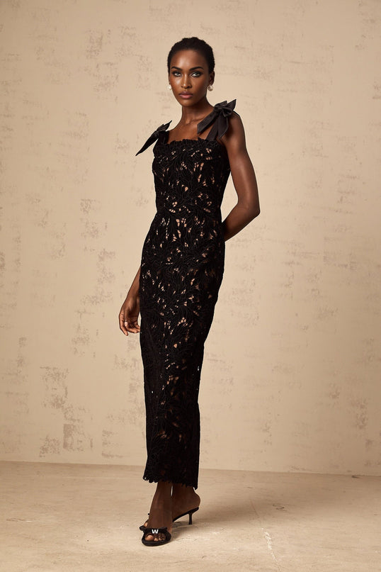 A long black maxi dress with floral embroidery details featuring a design named Eloise