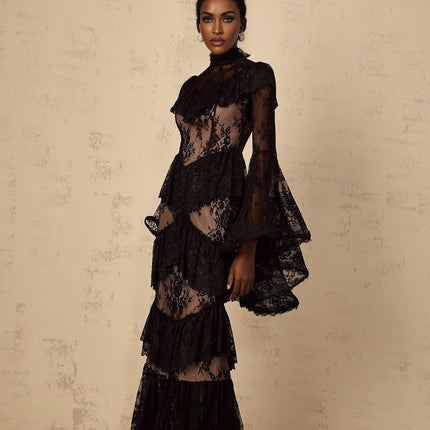 A long black maxi dress with floral lace details and ruffled accents throughout the design