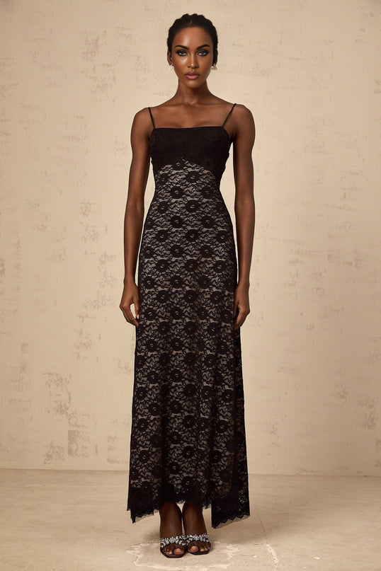 A long black maxi dress with floral lace pattern and open back design named Zelie