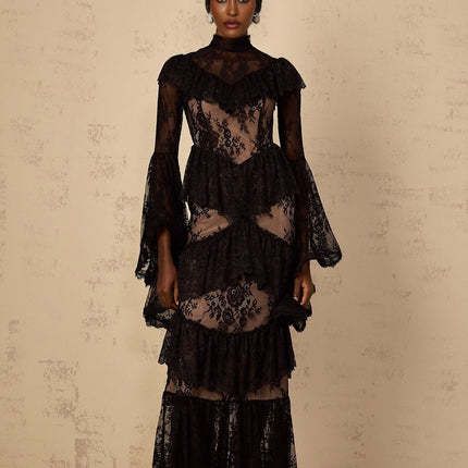 A long black maxi dress with floral lace pattern and ruffled details featuring a feminine silhouette