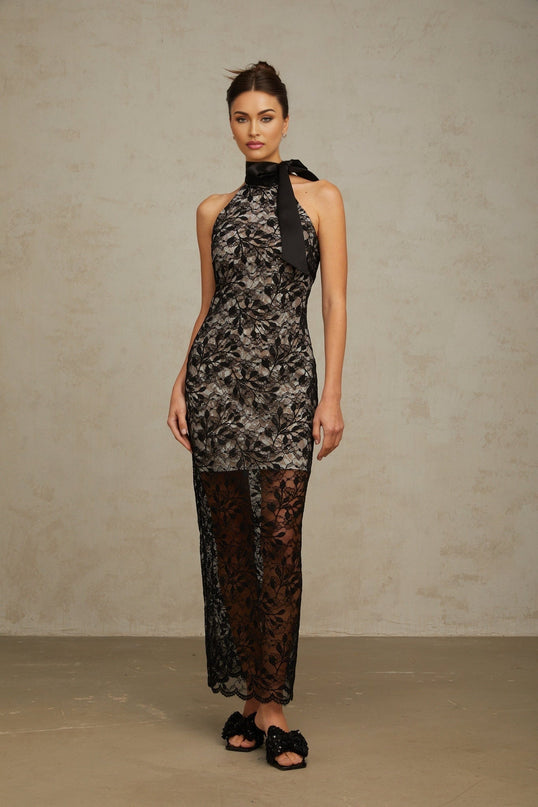 A long black maxi dress with floral lace pattern featuring a halter neckline and sleeveless design