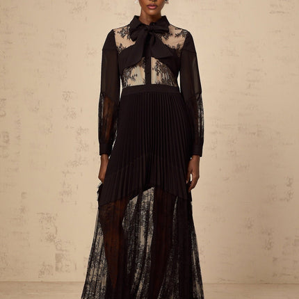 A long black maxi dress with pleats and floral lace panels featuring a feminine silhouette and elegant design