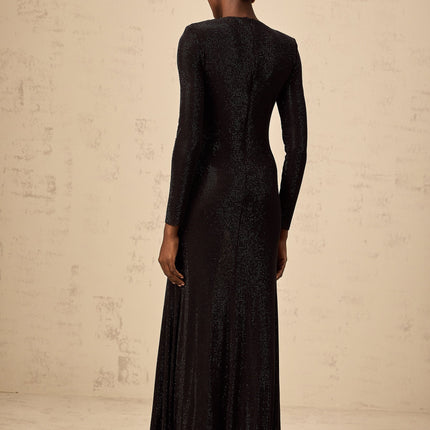 A long black maxi dress with ruched mesh fabric and rhinestone embellishments