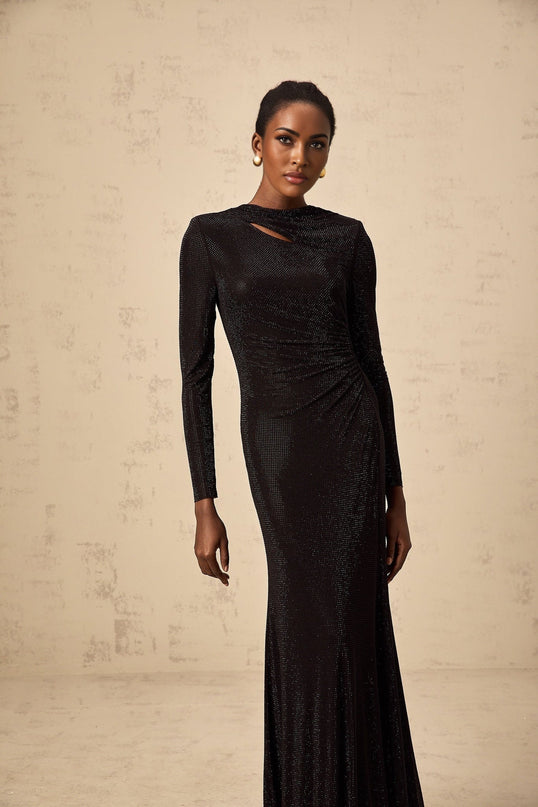 A long black maxi dress with ruched mesh fabric and rhinestone embellishments
