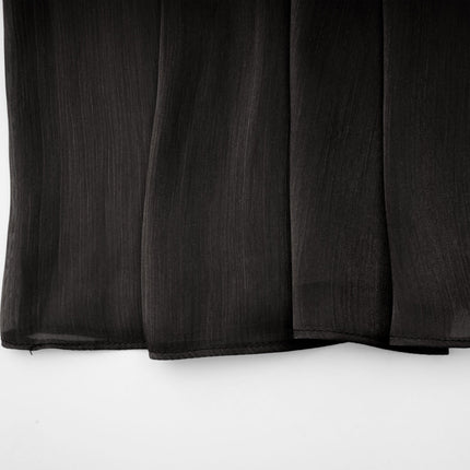 A long black pleated satin maxi dress with a flowing silhouette named Mila