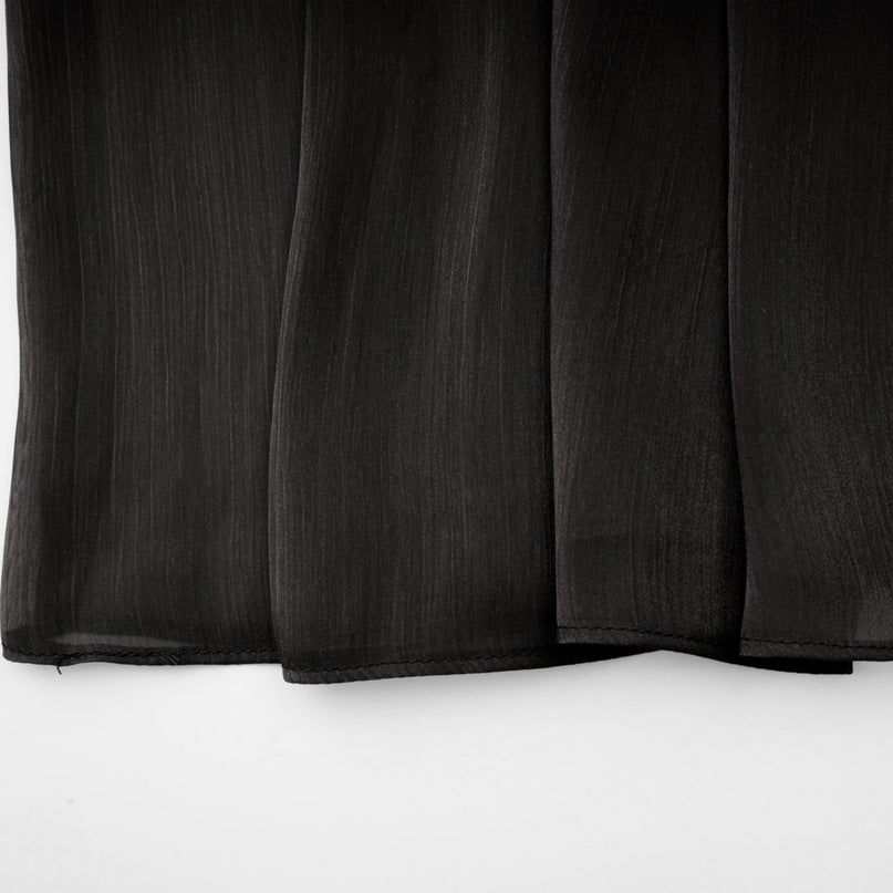 A long black pleated satin maxi dress with a flowing silhouette named Mila