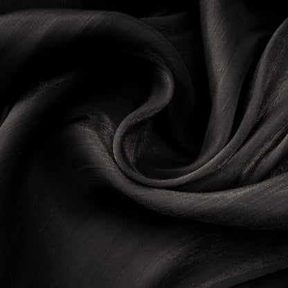 A long black pleated satin maxi dress with a flowing silhouette named Mila
