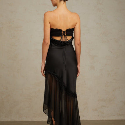 A long black satin maxi dress with sheer tulle panels elegant evening gown with a flowing silhouette
