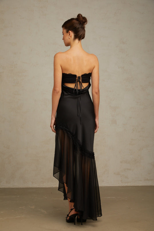 A long black satin maxi dress with sheer tulle panels elegant evening gown with a flowing silhouette