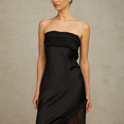 A long black satin maxi dress with sheer tulle panels elegant formal evening gown with fitted bodice and flowing skirt