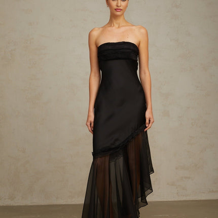 A long black satin maxi dress with sheer tulle panels featuring a flowing silhouette and elegant design