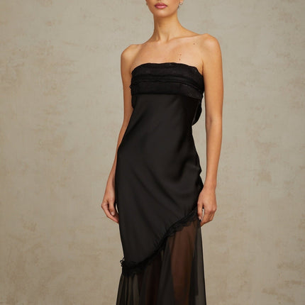 A long black satin maxi dress with sheer tulle panels featuring a sleek and elegant design