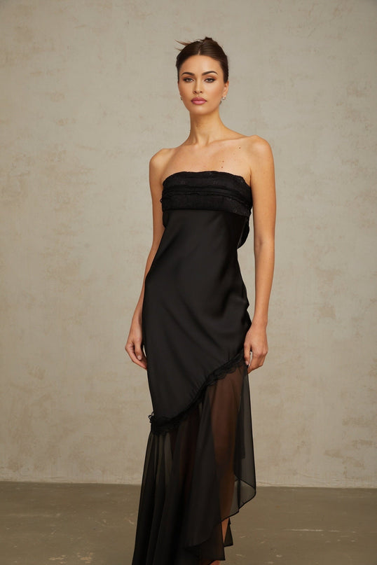 A long black satin maxi dress with sheer tulle panels featuring a sleek and elegant design