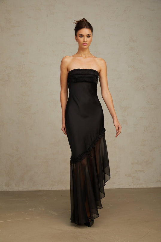 A long black satin maxi dress with sheer tulle panels featuring a sleek silhouette and elegant design