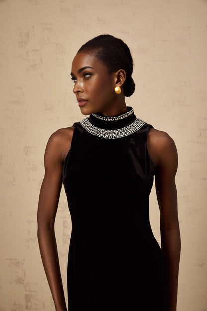 A long black velvet gown with crystal embellishments named Colette on a mannequin or model