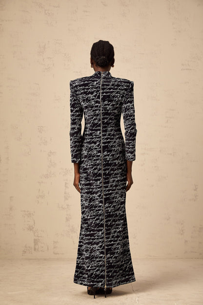 A long black velvet maxi dress with jade colored letter print design
