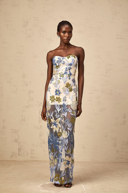 A long blue maxi dress with a corset bodice featuring sequined flower embroidery and a flowing tulle skirt