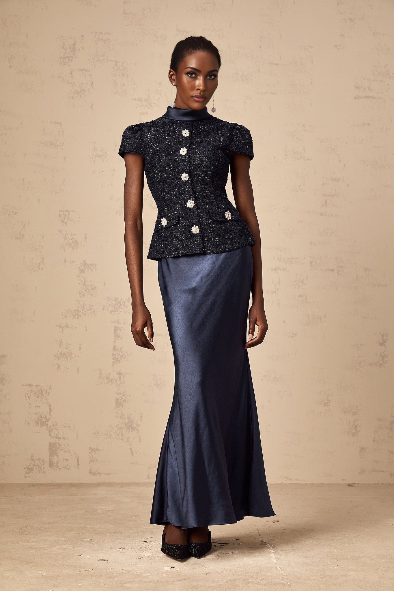 A long blue maxi dress with a fitted peplum waist and panelled design featuring a Josette style