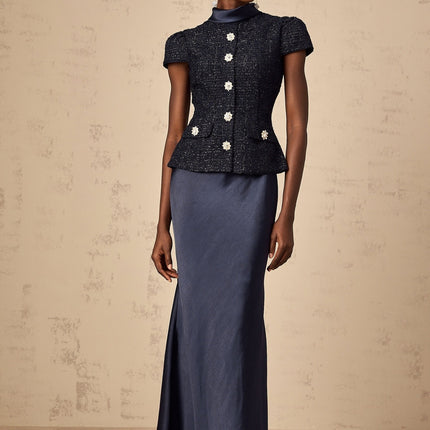A long blue maxi dress with a fitted peplum waist and panelled design featuring a Josette style