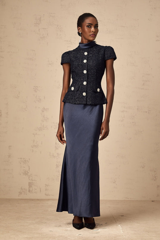 A long blue maxi dress with a fitted peplum waist and panelled design featuring a Josette style