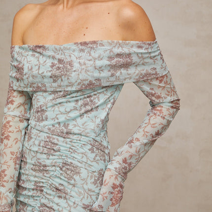 A long blue maxi dress with a floral print pattern and ruched detailing