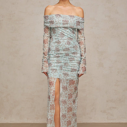 A long blue maxi dress with a floral print pattern and ruched detailing