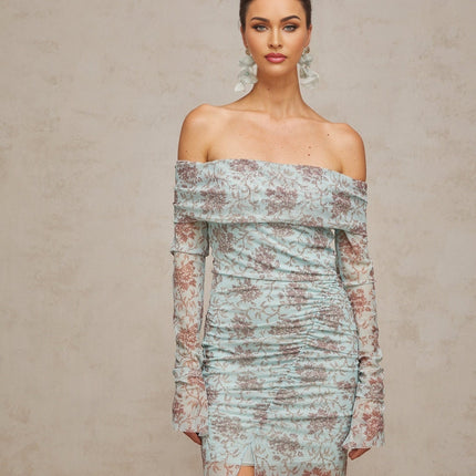 A long blue maxi dress with a floral print pattern and ruched details