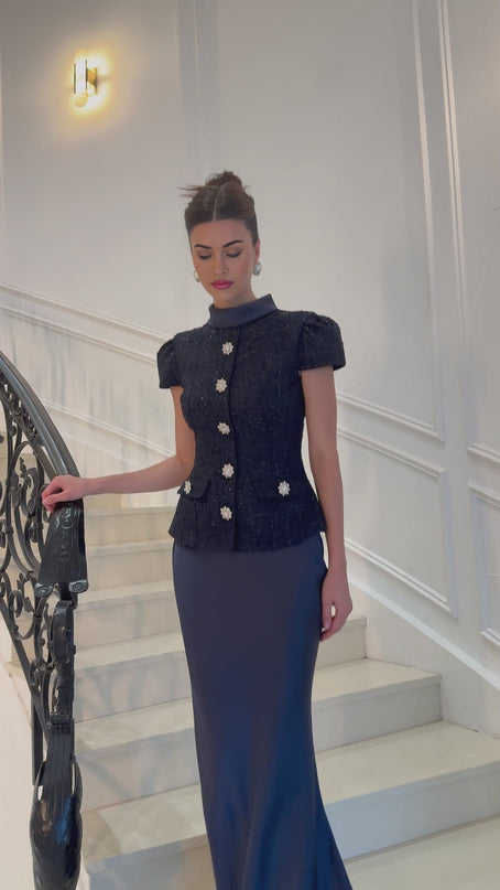 A long blue maxi dress with a peplum waist and paneled design features named Josette