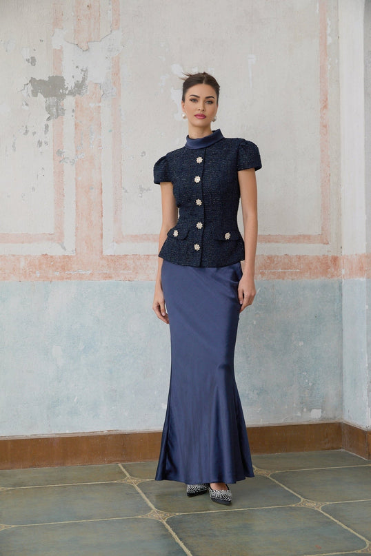 A long blue maxi dress with a peplum waist and paneled design featuring the Josette style
