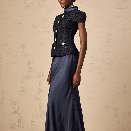 A long blue maxi dress with a peplum waist and panelled design featuring a fitted bodice and flowing skirt