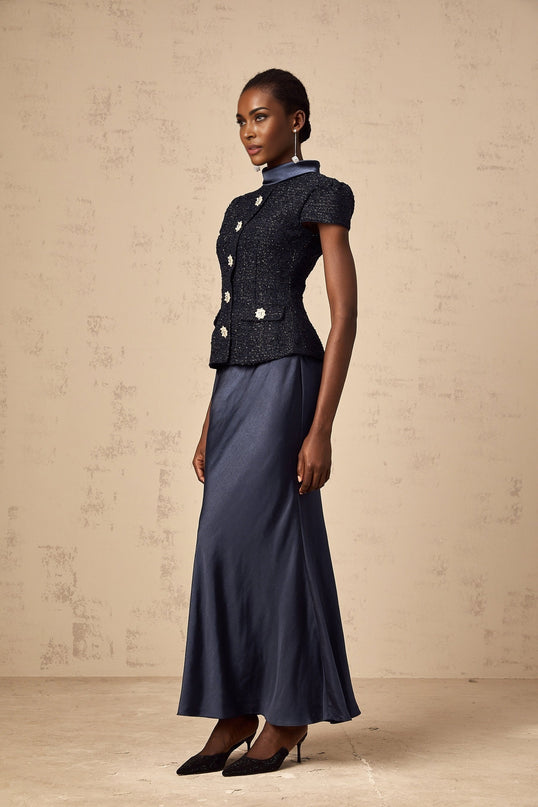 A long blue maxi dress with a peplum waist and panelled design featuring a fitted bodice and flowing skirt