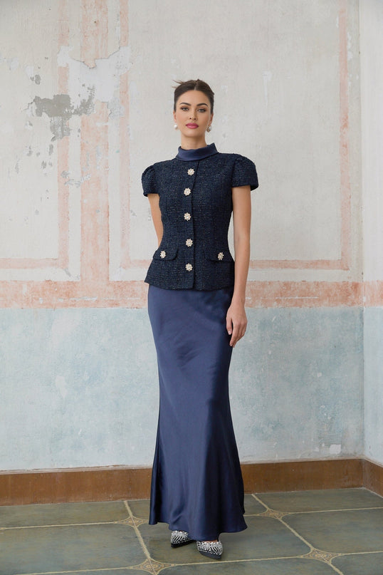 A long blue maxi dress with a peplum waist and panelled design featuring the Josette style