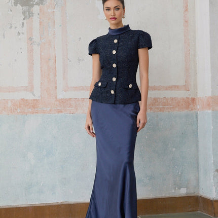 A long blue maxi dress with a peplum waist and panelled design featuring the Josette style