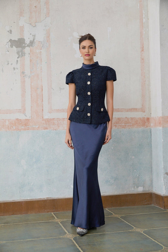 A long blue maxi dress with a peplum waist and panelled design featuring the Josette style