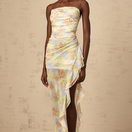 A long blue maxi dress with an asymmetric design featuring a floral print pattern and ruched detailing