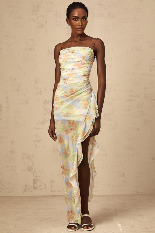 A long blue maxi dress with an asymmetric design featuring a floral print pattern and ruched detailing