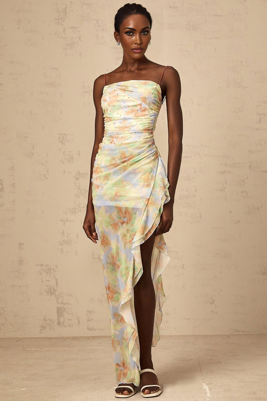 A long blue maxi dress with an asymmetric design featuring a floral print pattern and ruched detailing