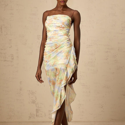 A long blue maxi dress with an asymmetric design featuring a floral print pattern and ruched details