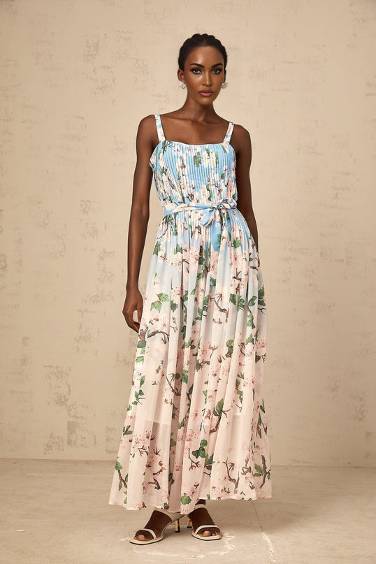 A long blue maxi dress with floral print pattern and pleated design