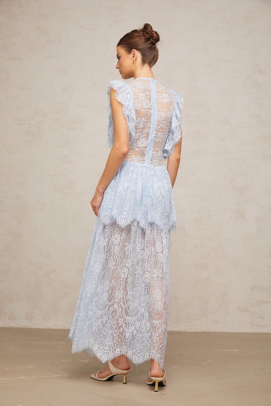 A long blue maxi dress with layered lace details and a capucine color accent