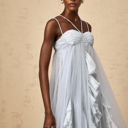 A long blue maxi dress with multiple layers of ruffled tulle creating a flowing and ethereal appearance