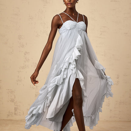 A long blue maxi dress with multiple layers of ruffled tulle fabric creating a flowy silhouette